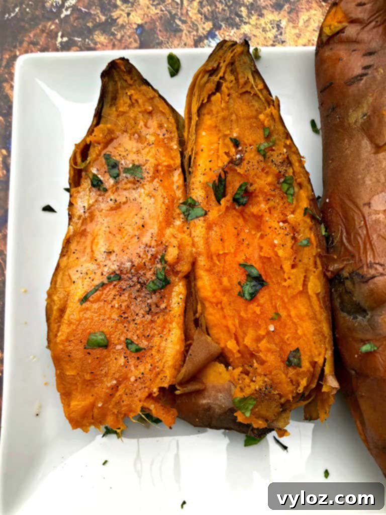 Two halves of Instant Pot sweet potato on a white plate
