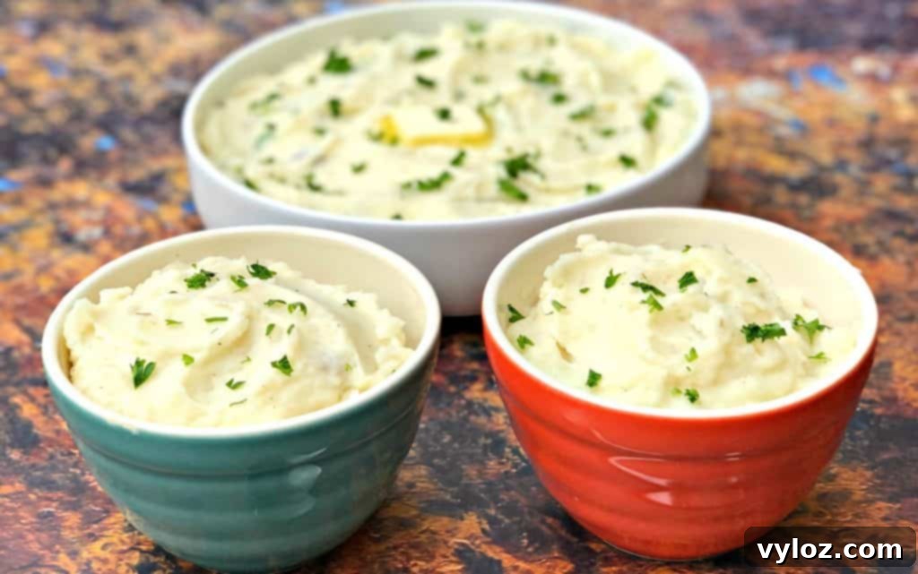 Three bowls of fluffy Instant Pot garlic mashed potatoes, ready to be served.