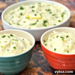 Three bowls of fluffy Instant Pot garlic mashed potatoes with a creamy texture, ready for serving.