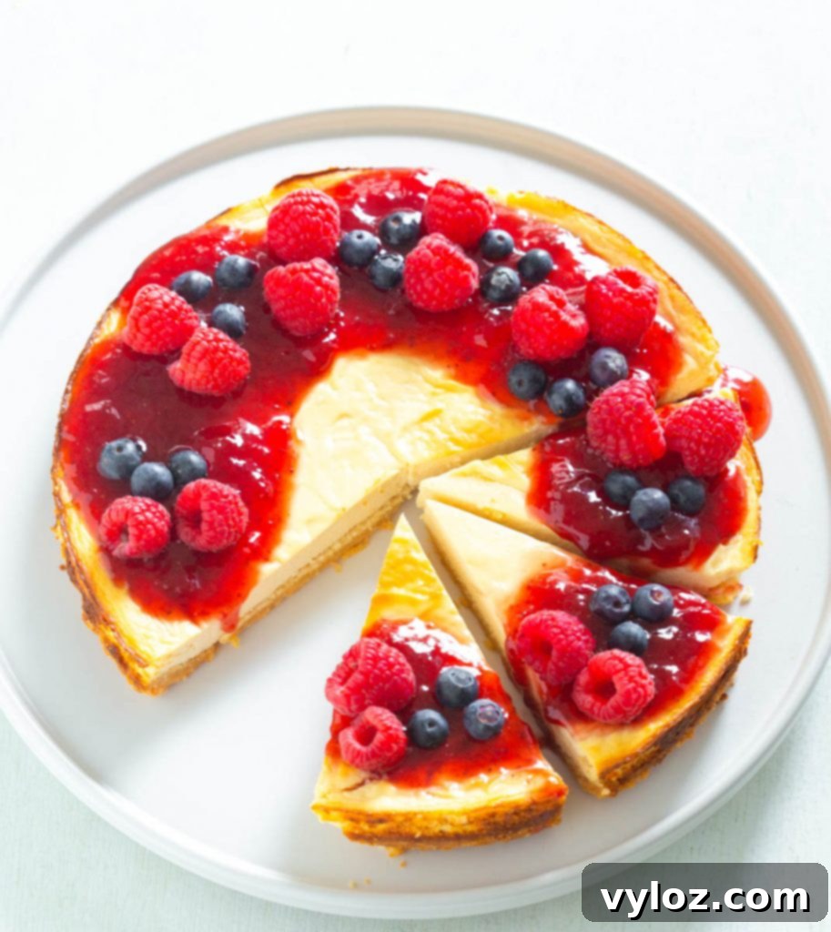 A vibrant display of fresh berries atop a sugar-free cheesecake, with caramel drizzle and whipped cream, creating an appetizing dessert.