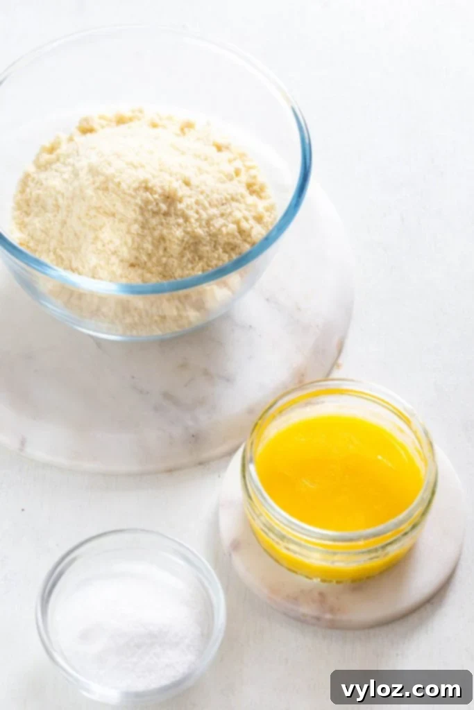 Ingredients for a sugar-free cheesecake laid out: cream cheese blocks, eggs, and a bowl of granular sweetener, ready for mixing.