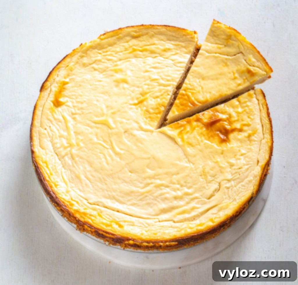 A close-up of a keto low-carb cheesecake slice with caramel and whipped cream, highlighting the smooth texture and delicious toppings.