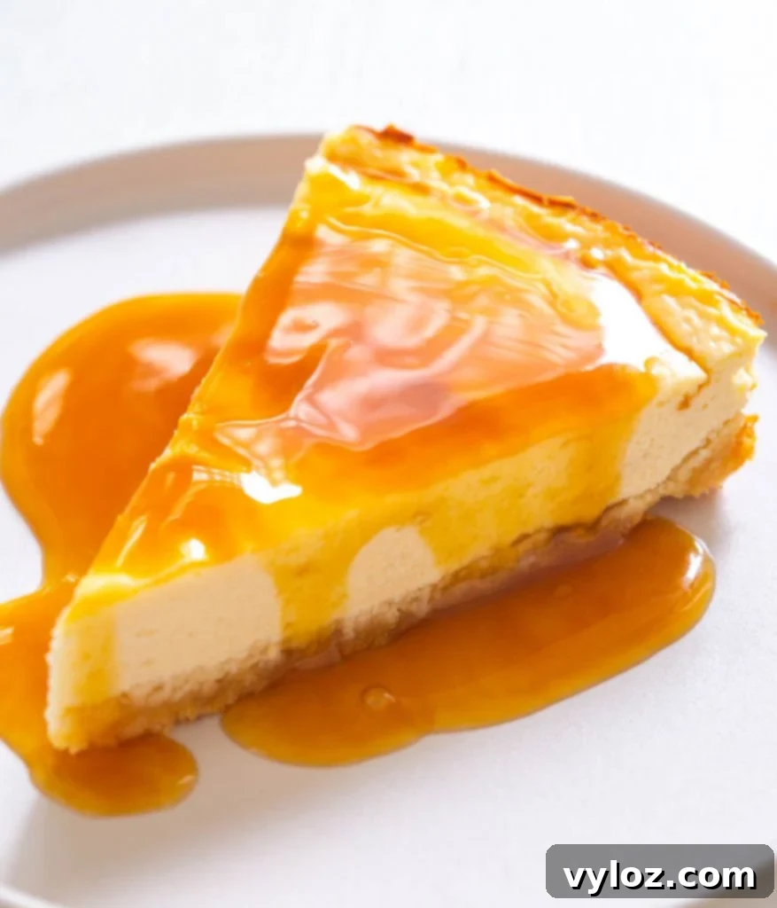 A generous slice of keto low-carb cheesecake, served plain on a white plate, highlighting its smooth and creamy texture.