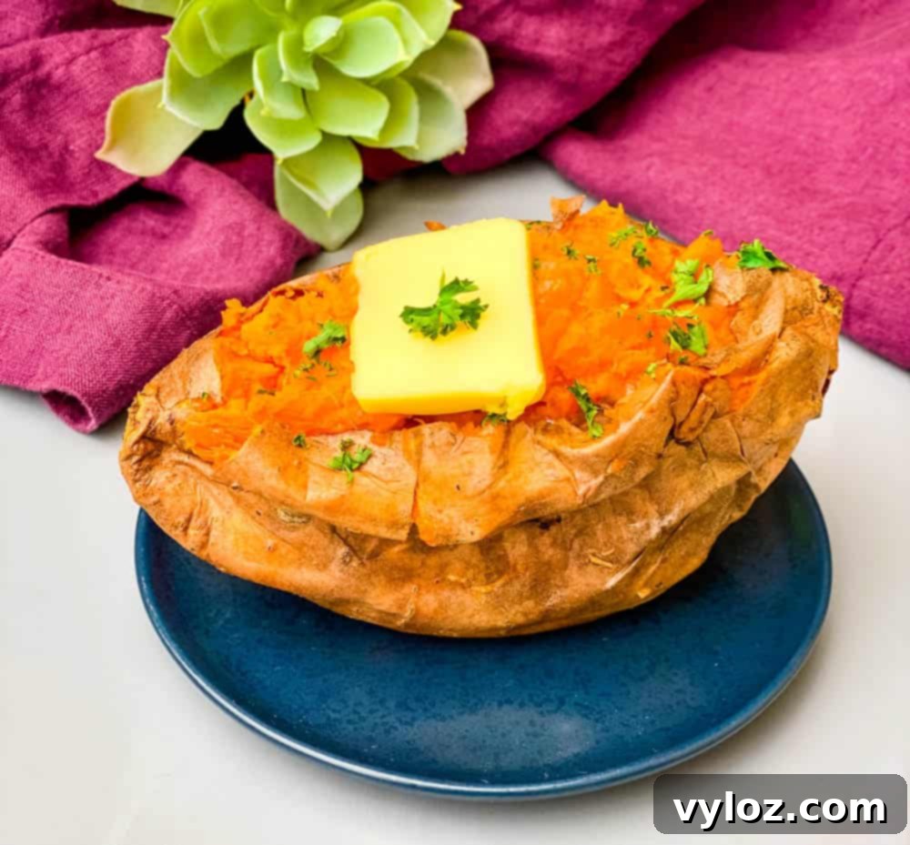 air fryer sweet potato on a blue plate with butter