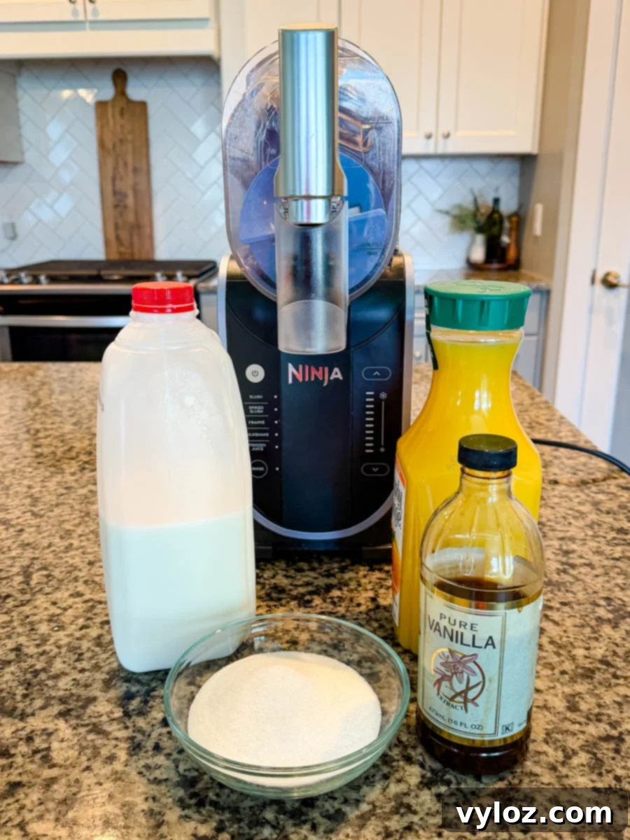 Ingredients for Ninja Slushi Orange Julius: milk, sugar, vanilla extract, orange juice