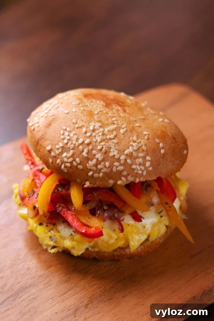 Speedy Pepper & Egg Sandwich: Ready in a Flash! 2 Pepper and Egg Sandwich with soft scrambled eggs, melty cheese, and sautéed peppers and onions on a lightly butter-toasted bun.